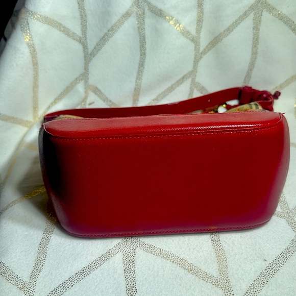 Small Burberry handbag with gold Burberry charm on the side. - Picture 3 of 4